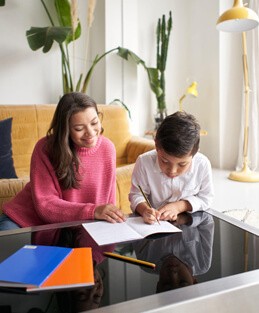 A parent helping a child with homework at home