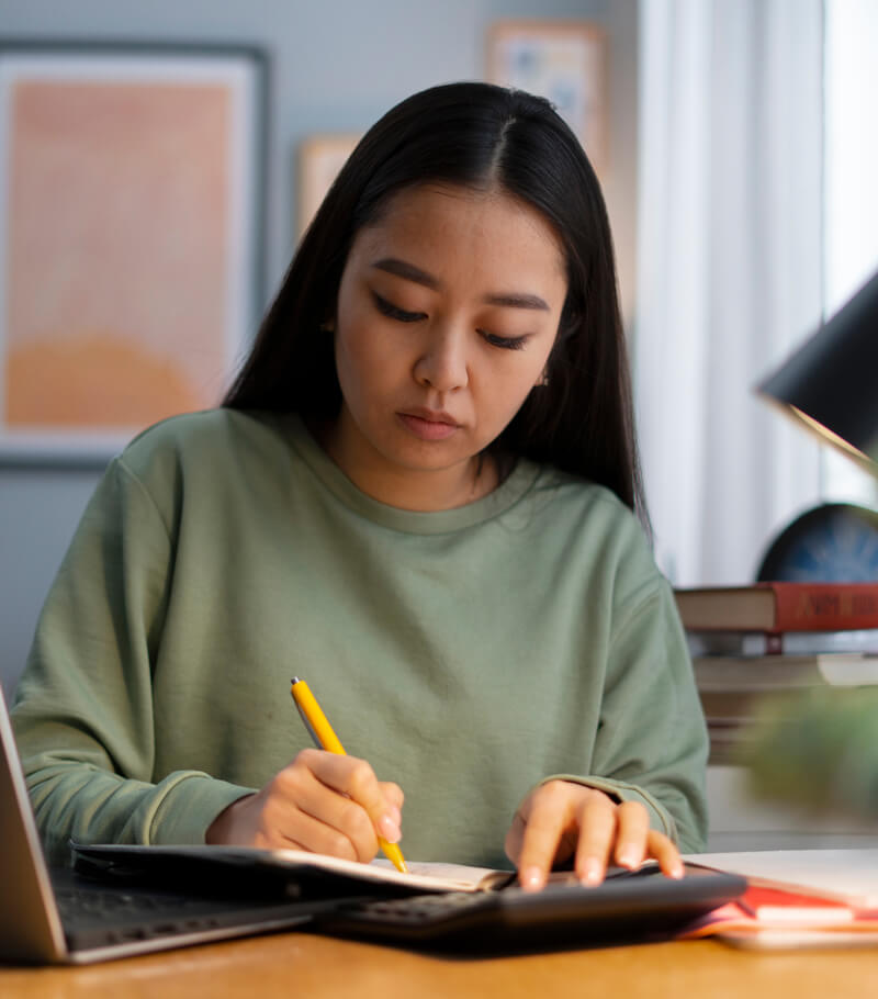 A student concentrating on her notes during a study session
